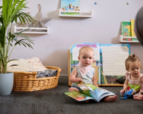 The Library Babies reading a book at The Rocking Horse Nursery