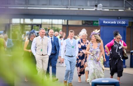Racegoers walking into Newbury Racecourse