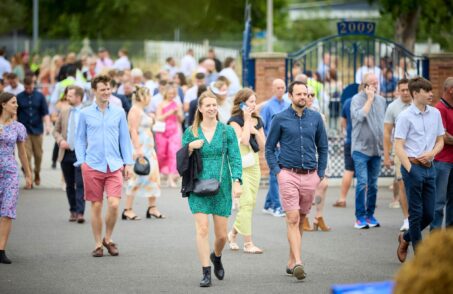 Racegoers walking into Newbury Racecourse North Entrance
